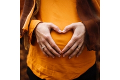 Someone holding their tum tum.